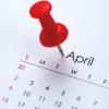 Calendar month of April with red push pin