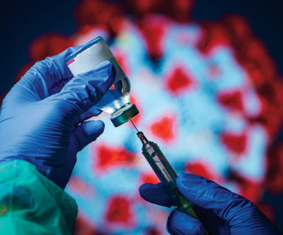 gloved hand needle vial vaccine coronavirus